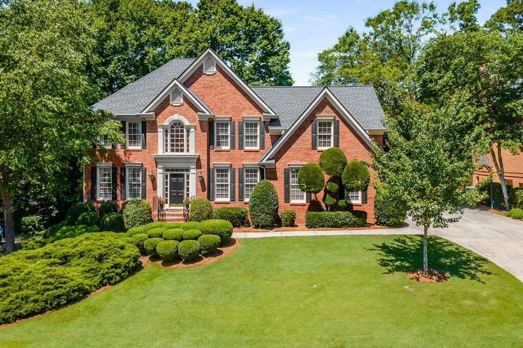 Large brick house with a manicured lawn