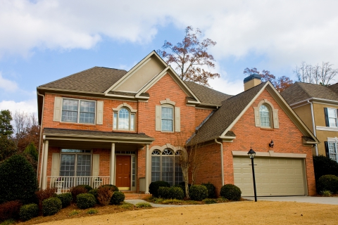 A charming two-story brick home with a symmetrical facade